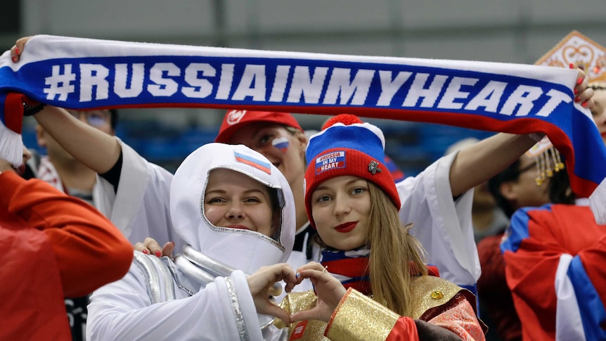 Russia supporters at Pyeongchang wave a flag reading Russia in my heart