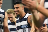 Tim Kelly celebrates with his Geelong teammates after beating the Adelaide Crows.