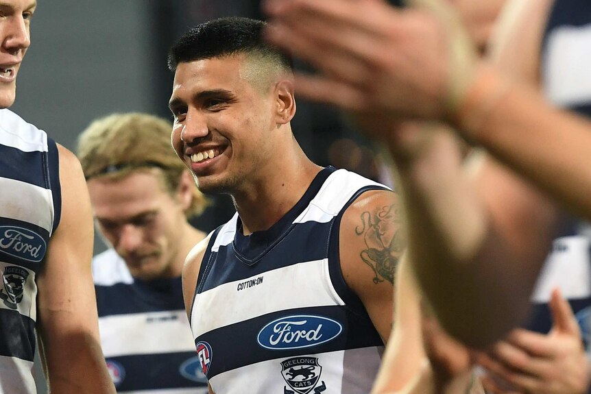Tim Kelly celebrates with his Geelong teammates after beating the Adelaide Crows.