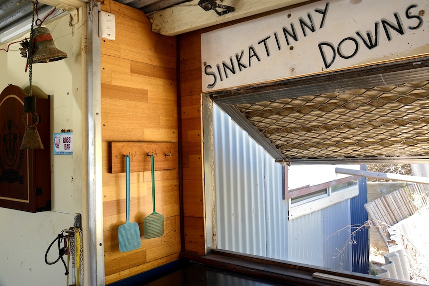 a sign inside a shack reads Sinkatinny Downs
