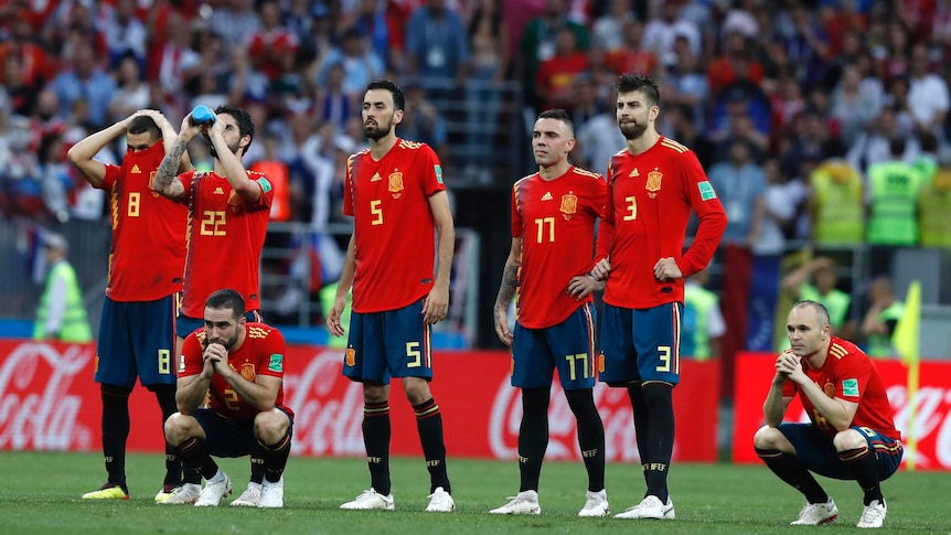 Spain's players are disappointed during the shootout loss