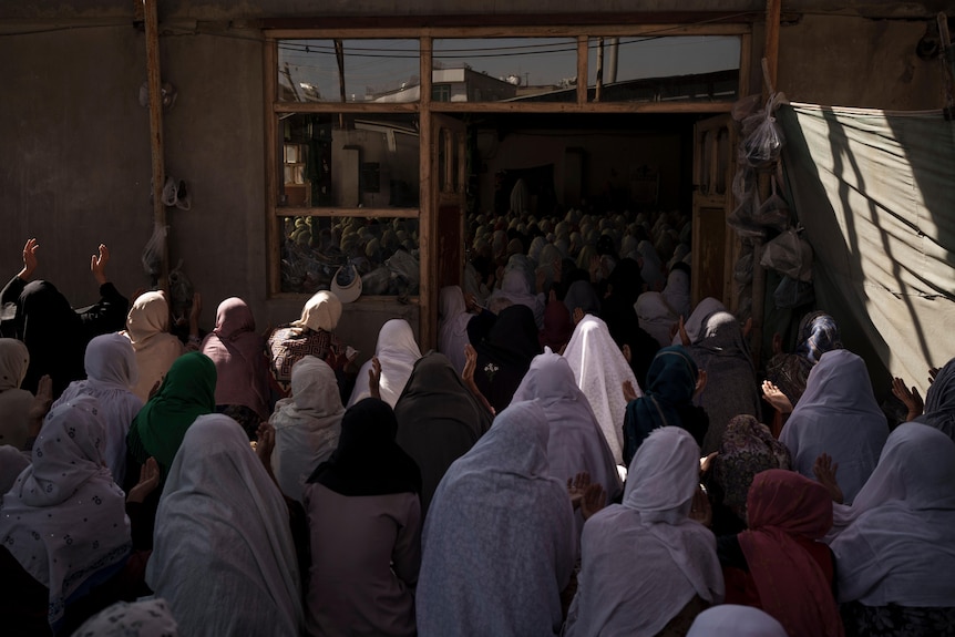 Afghan women pray in a Shiite mosque