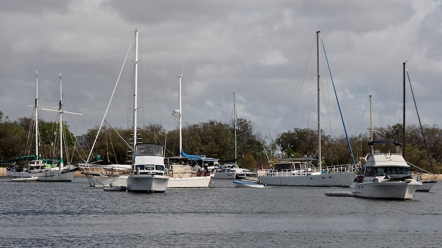 11 boats are anchored next to each other on the Gold Coast Broadwater