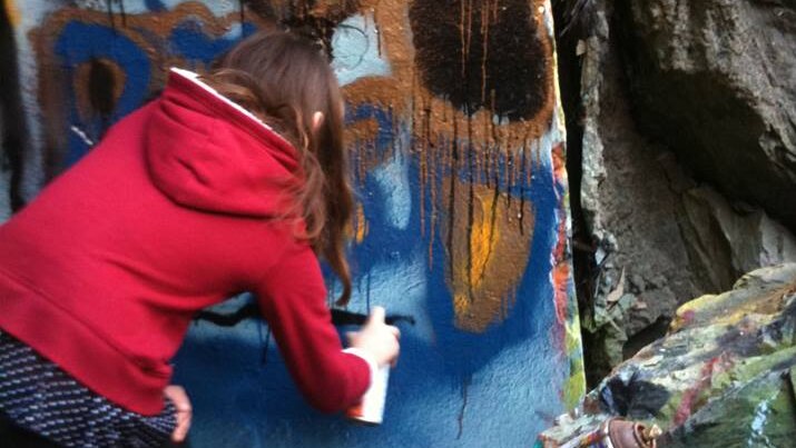 Artist painting on the Ernest Junction Railway Tunnel