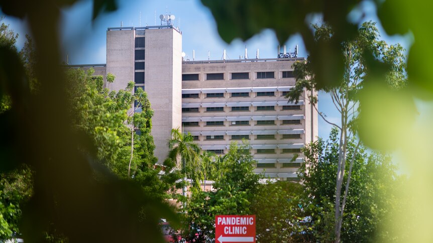 a multi-storey hospital building with a sign saying pandemic clinic visible 