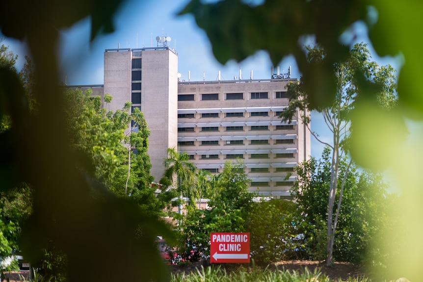 a multi-storey hospital building with a sign saying pandemic clinic visible 