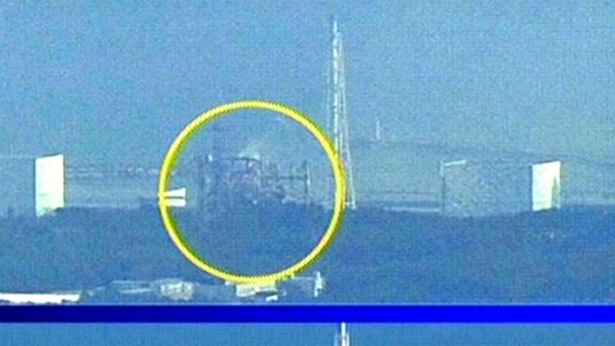 The Fukushima nuclear power station before (bottom) and after (top) a hydrogen explosion at the number three reactor.