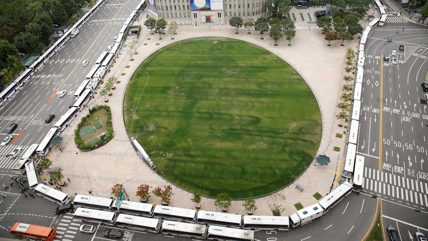 A wall of buses makes a ring around Gwanghwamun square to prevent protests in Seoul, South Korea