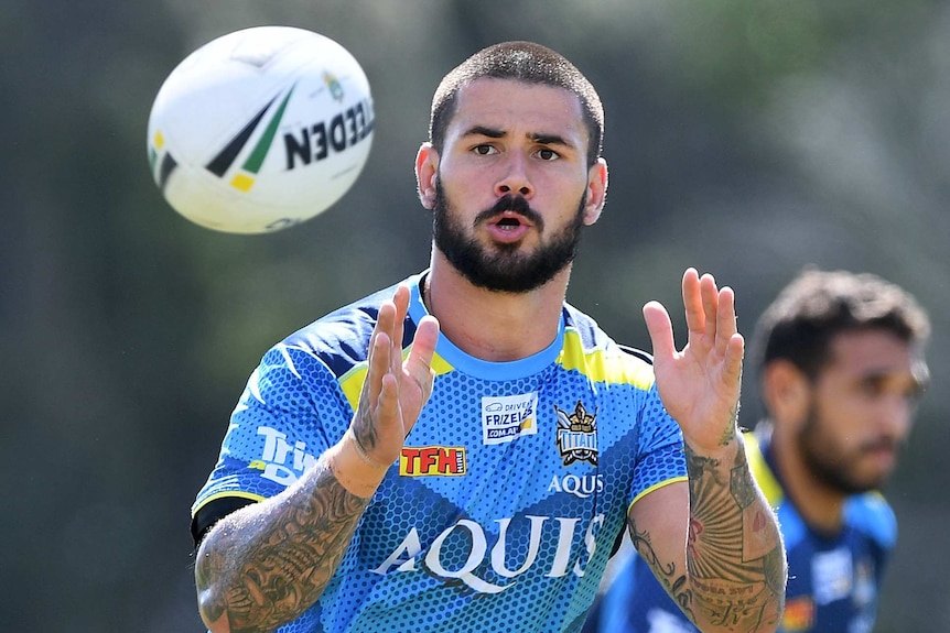 Nathan Peats catches a ball at Gold Coast Titans training