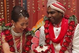 Matisse Yee and husband Vick Satgunasingam wear traditional Indian clothes at their wedding.