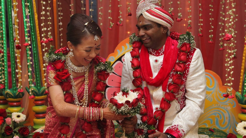 Matisse Yee and husband Vick Satgunasingam wear traditional Indian clothes at their wedding.