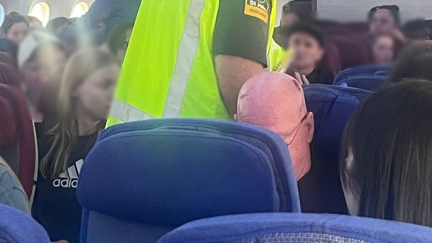A man is seen bleeding from his head while emergency services are on board 