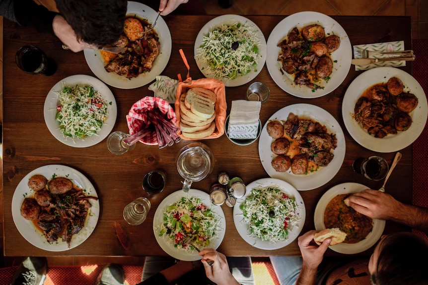 White dinner plates with assorted foods