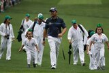 Louis Oosthuizen walks the Augusta fairway with his kids