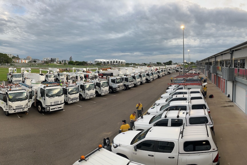 emergency trucks and cars lined up at a staging area
