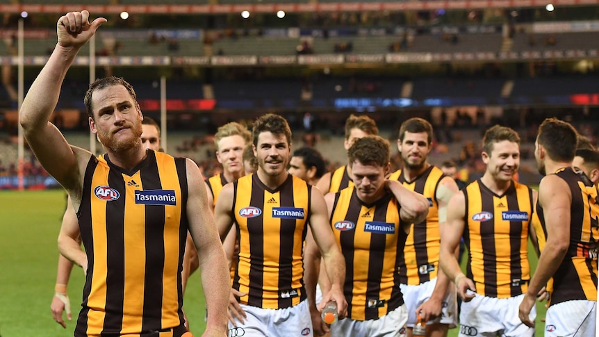 Jarryd Roughead leads Hawthorn off after the Hawks' win over Melbourne