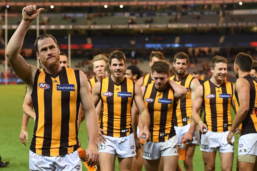 Jarryd Roughhead (L) leads Hawthorn off the ground after the Hawks' win over Melbourne at the MCG.