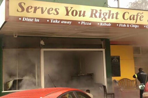 Firefighters at smoky Serves You Right Cafe in Ravenshoe after a gas explosion.