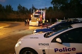 Police inspect trucks at a Baiada chicken processing plant after a driver was allegedly involved in a fatal hit-and-run.