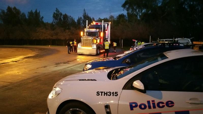 Police inspect trucks at a Baiada chicken processing plant after a driver was allegedly involved in a fatal hit-and-run.