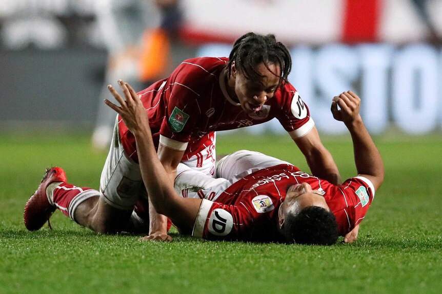 Bobby Reid and Korey Smith hug each other as they celebrate Bristol City's win over Manchester United.