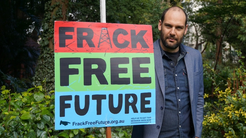 Piers Verstegen holds a sign reading "Fracking Free Future". July 22, 2017.