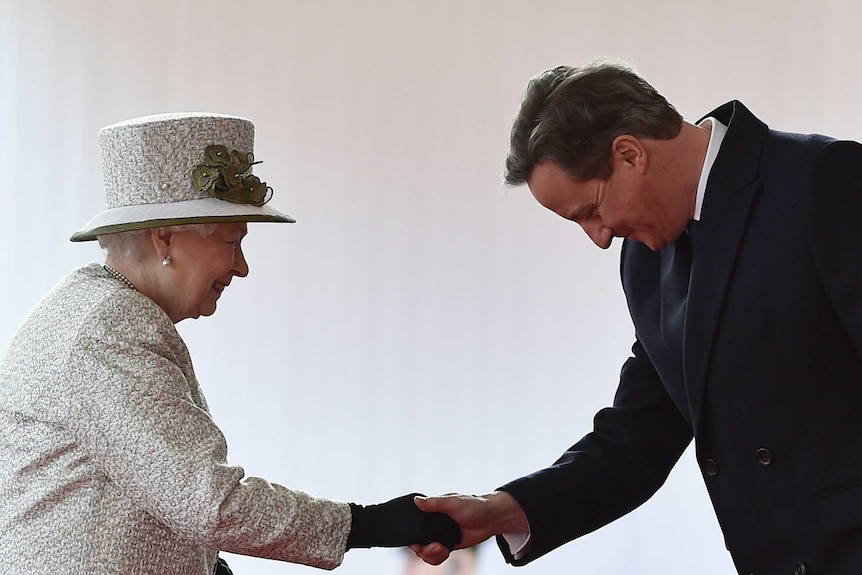 Britain's Prime Minister David Cameron bows to Queen Elizabeth II.