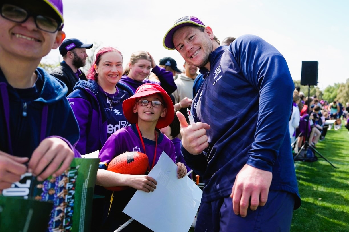 A football player meets fans at a training session