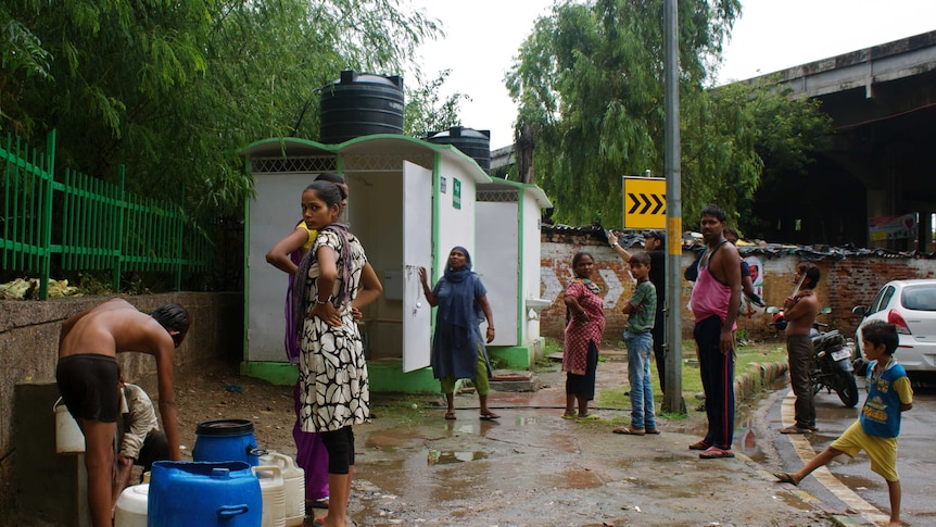 Residents of a slum built under an overpass in South Delhi