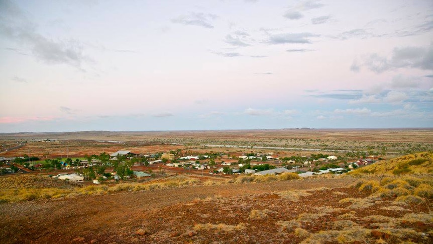 A view of the red dirt, spinifex and low-lying buildings in the remote Pilbara town of Roebourne.