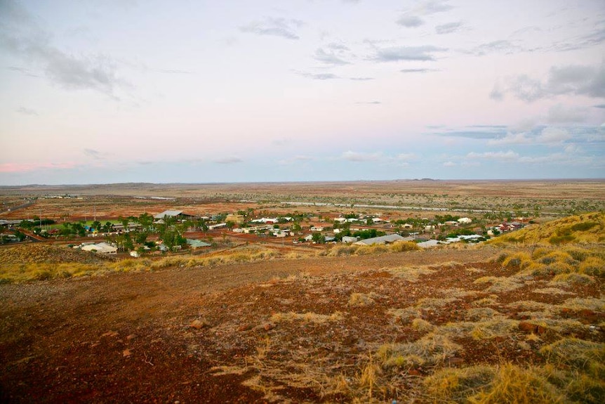 A view of the red dirt, spinifex and low-lying buildings in the remote Pilbara town of Roebourne