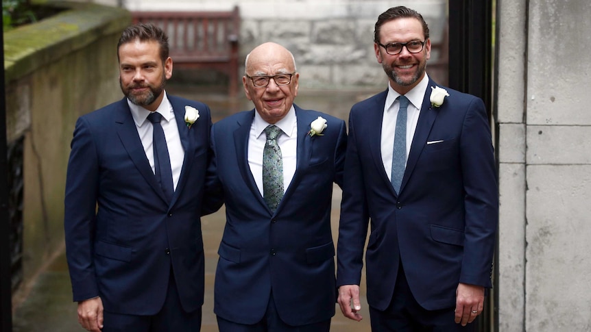 Rupert Murdoch poses for a photograph with his sons Lachlan and James outside a church.