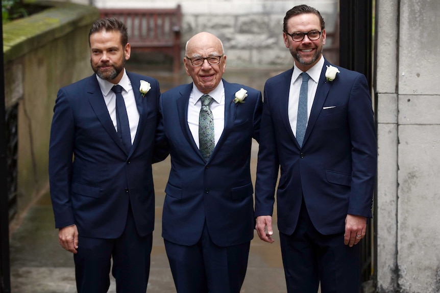 Rupert Murdoch poses for a photograph with his sons Lachlan and James outside a church.