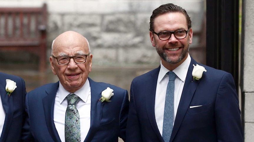 Rupert Murdoch poses for a photograph with his sons Lachlan and James outside a church.