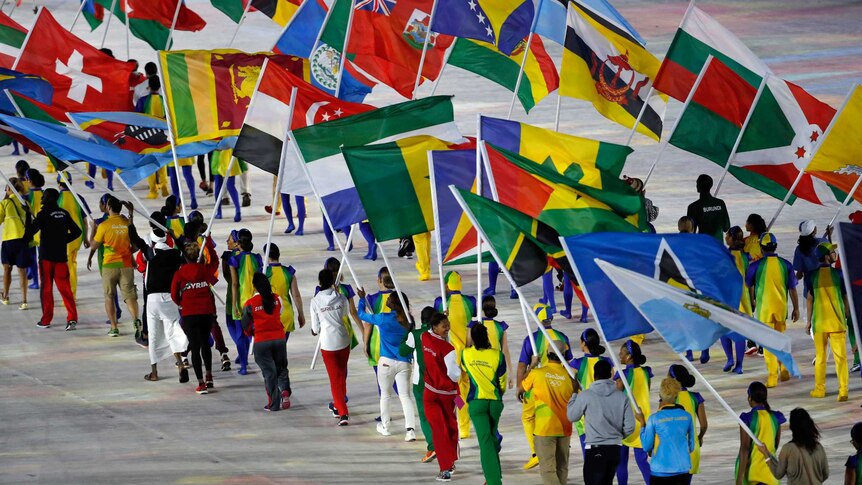 Flag bearers walk into the stadium during the Olympics closing ceremony.