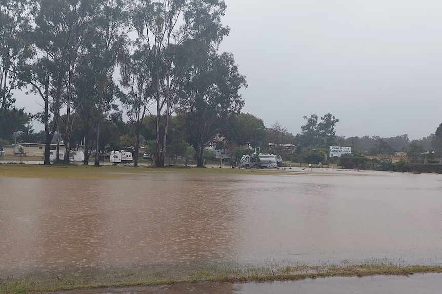 Floodwaters cover a field at Nanango caravan park