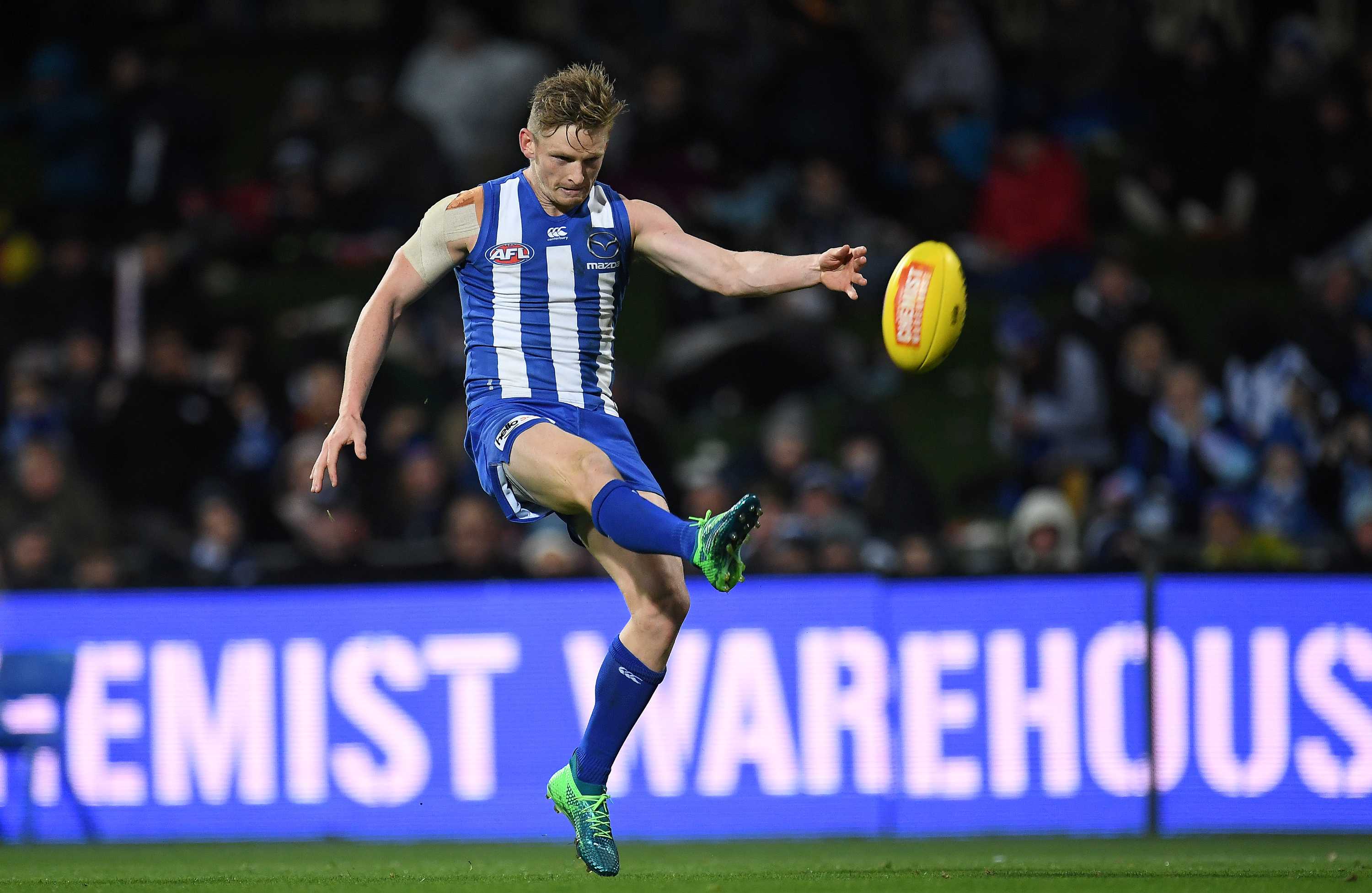 Jack Ziebell kicking a football 
