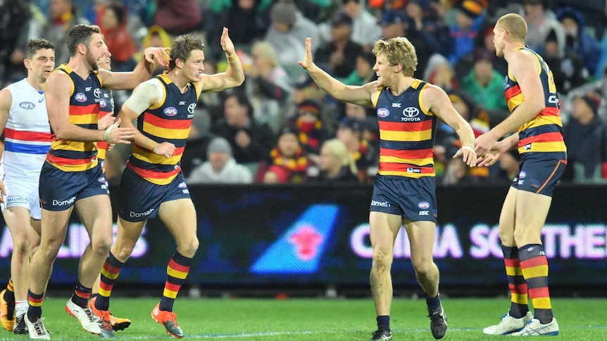 Crows players celebrate a goal against the Western Bulldogs at Adelaide Oval on July 7, 2017.