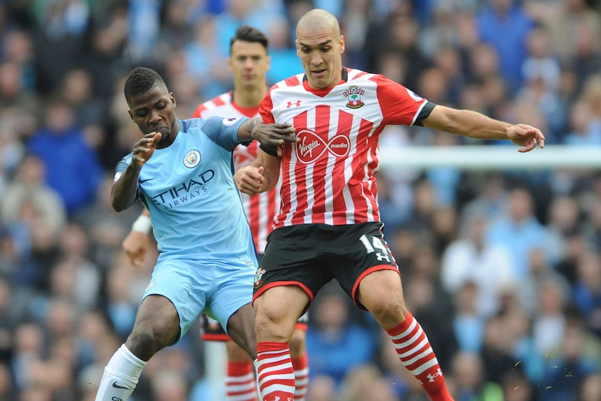 Kelechi Iheanacho battles for the ball with Oriol Romeu