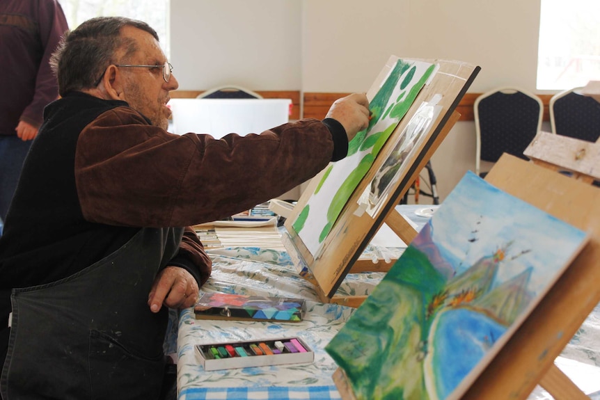 Ian Roden working on his artwork in Launceston