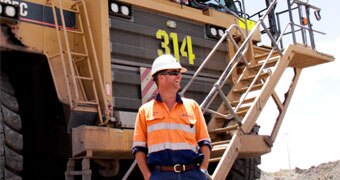 Mine truck and worker at Acland mine, Queensland
