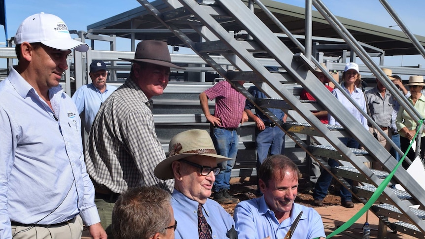 100-year-old George Coyle cutting the ribbon with dignitaries to officially open the Wodonga saleyards.