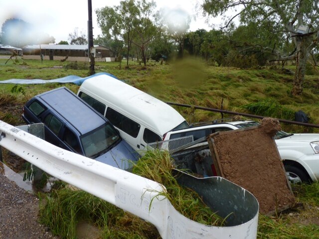 Cars sit in a creek bed in Warmun
