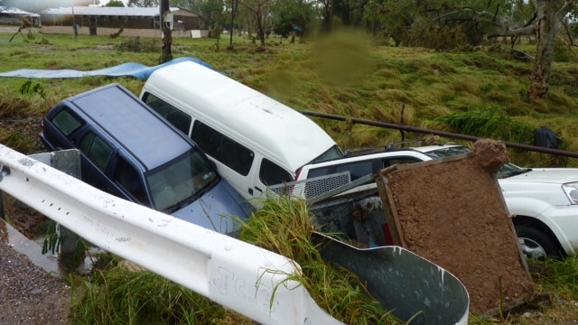 Cars sit in a creek bed in Warmun