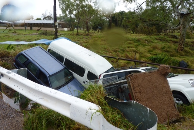 Cars sit in a creek bed in Warmun