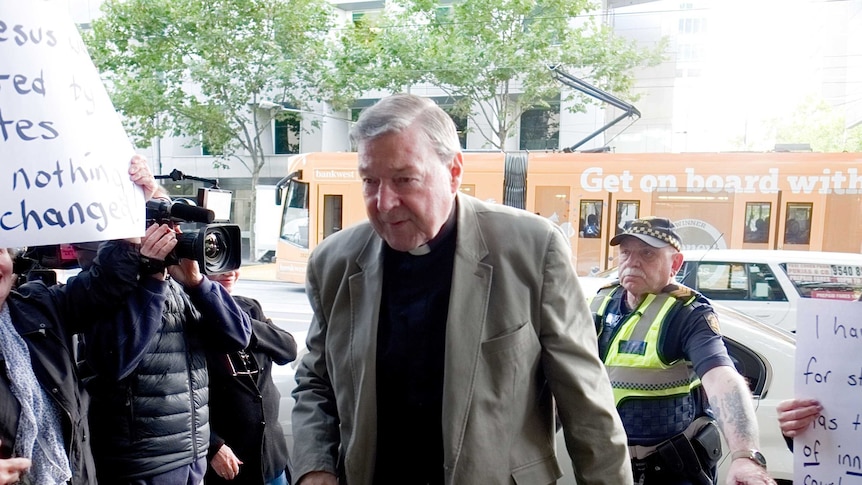 Cardinal George Pell walks into the Melbourne Magistrates' Court.