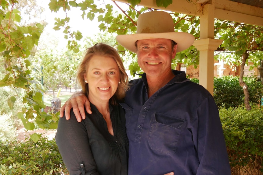 Wife and husband, Jacinta and Brendan Cullen, stand side-by-side hugging.