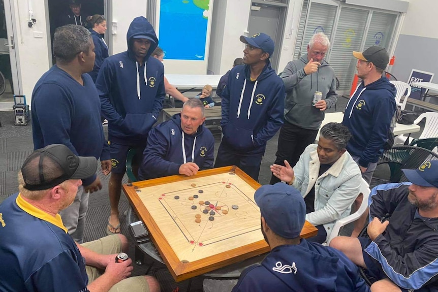 Carlisle Park cricketers play Indian boardgame Carrom in Melbourne.