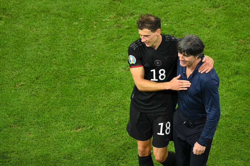 German football coach Joachim Löw puts his arm around goalscorer Leon Goretzka after the team's win.,