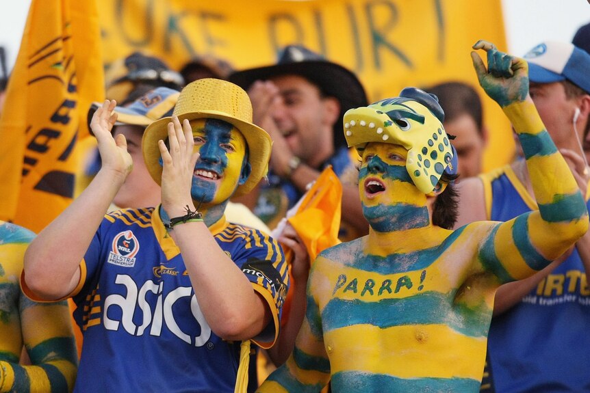 A group of Parramatta fans celebrate a try
